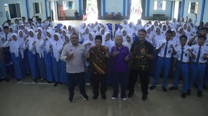 Foto bersama antara kepala sekolah, para siswa dan jurnalis